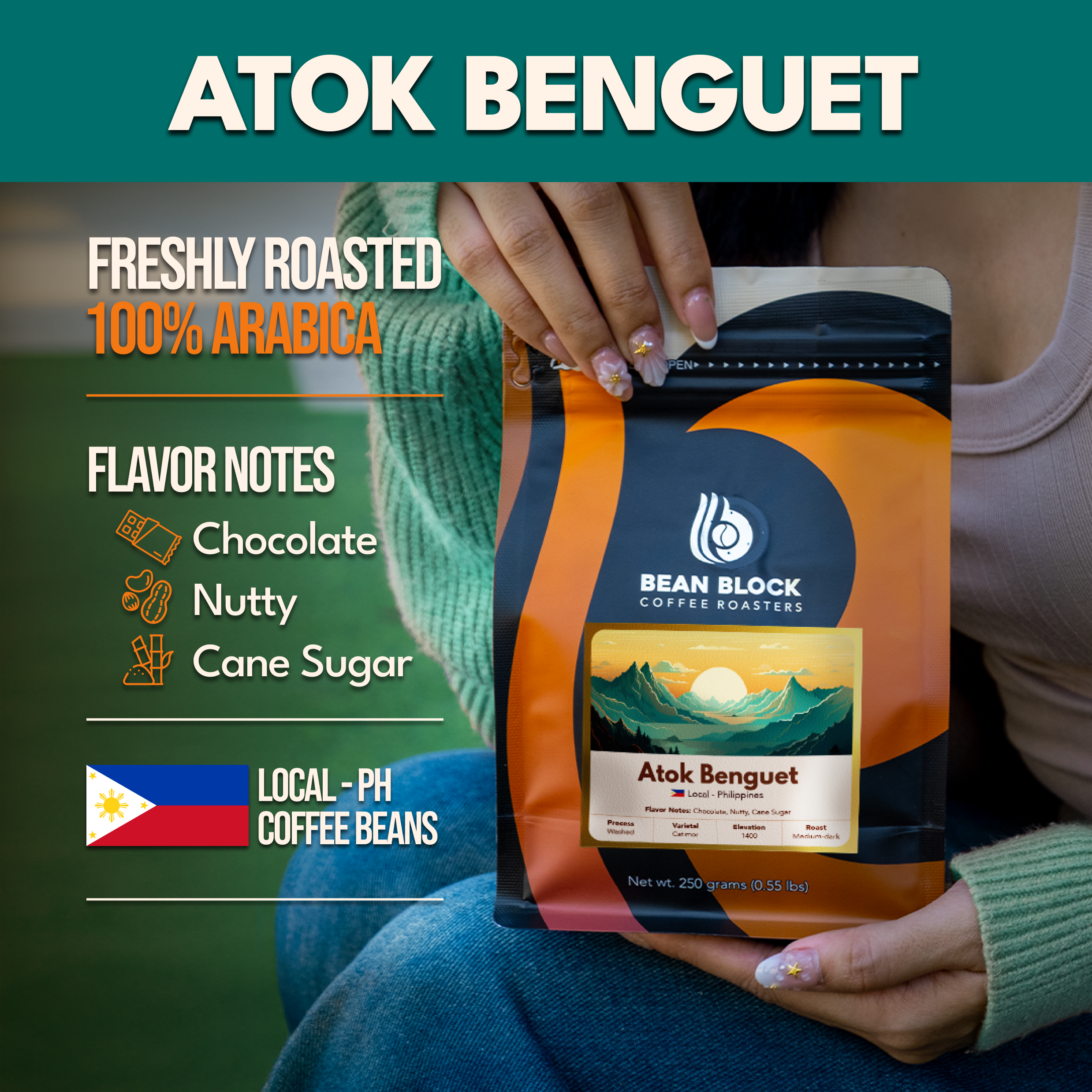 A person holds a stand-up pouch of Bean Block Coffee Roasters Atok Benguet coffee beans. The package is orange, black, and cream with the Bean Block Coffee Roasters logo.