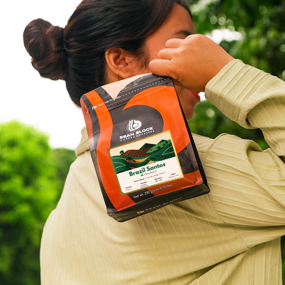 Coffee Bean Pouch of Brazil Santos Coffee Beans in Bean Block Coffee Roasters 250g pouch roasted in Philippines. Lifestyle style of shot holding the Bean Block coffee pouch