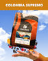 Bean Block Coffee Roasters Colombia Supremo 250g coffee bag with a hand holding it against a blue sky background.